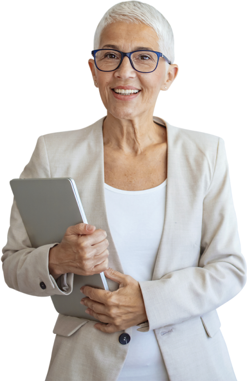 Experienced retired teacher older woman holding a laptop in front of a faded classroom background