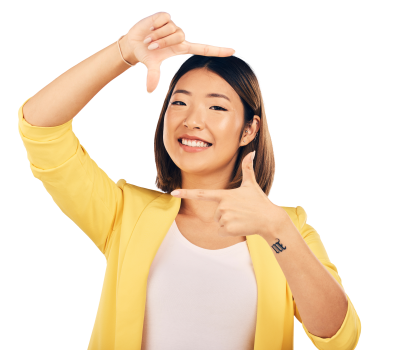 Young woman with yellow jacket framing her face with her fingers